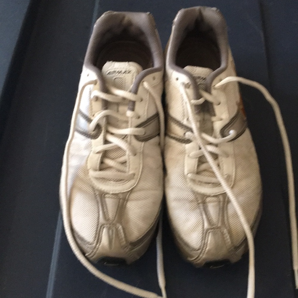 Silver white and gold Nike tennis shoes